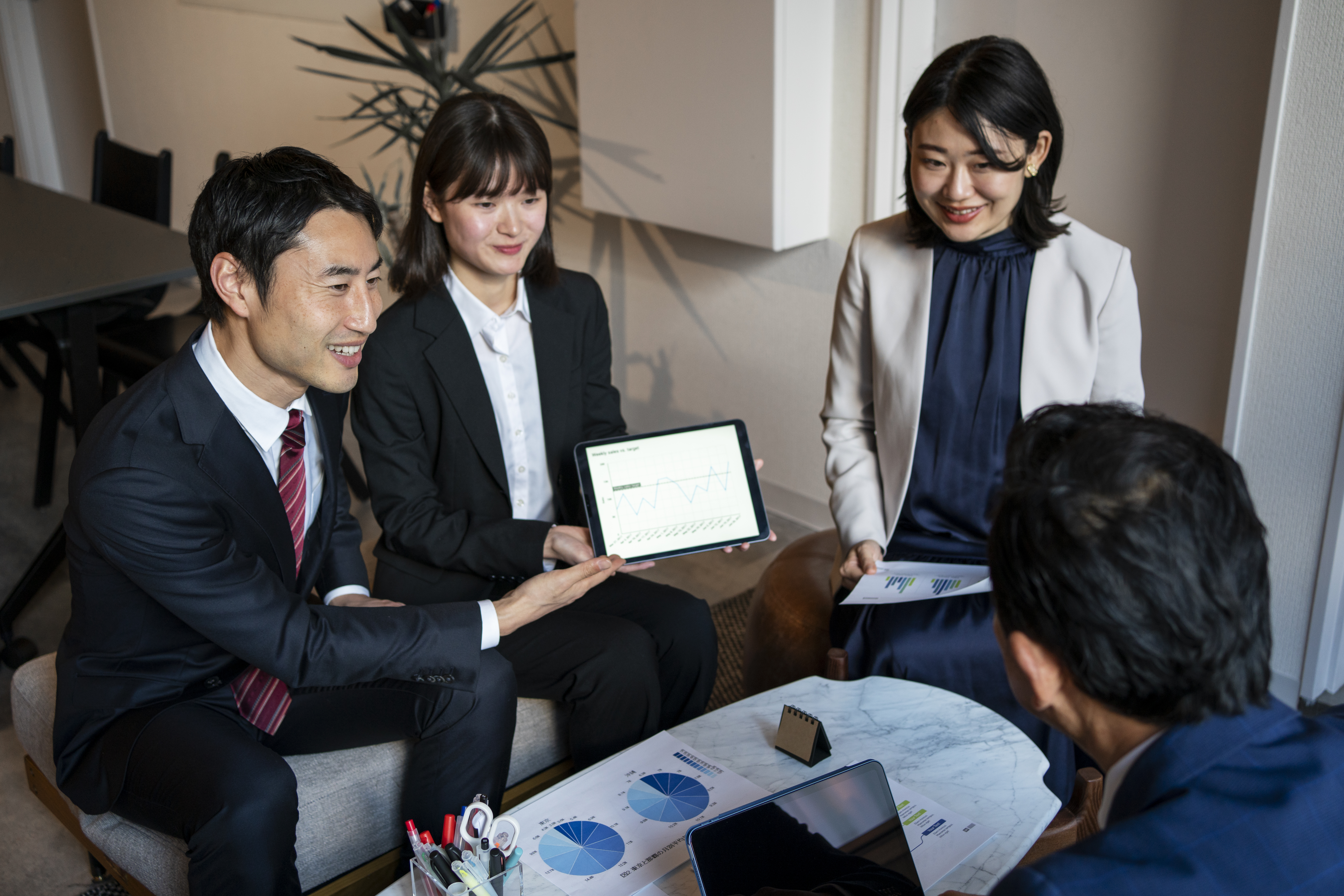 Business professionals meeting around a coffee table.